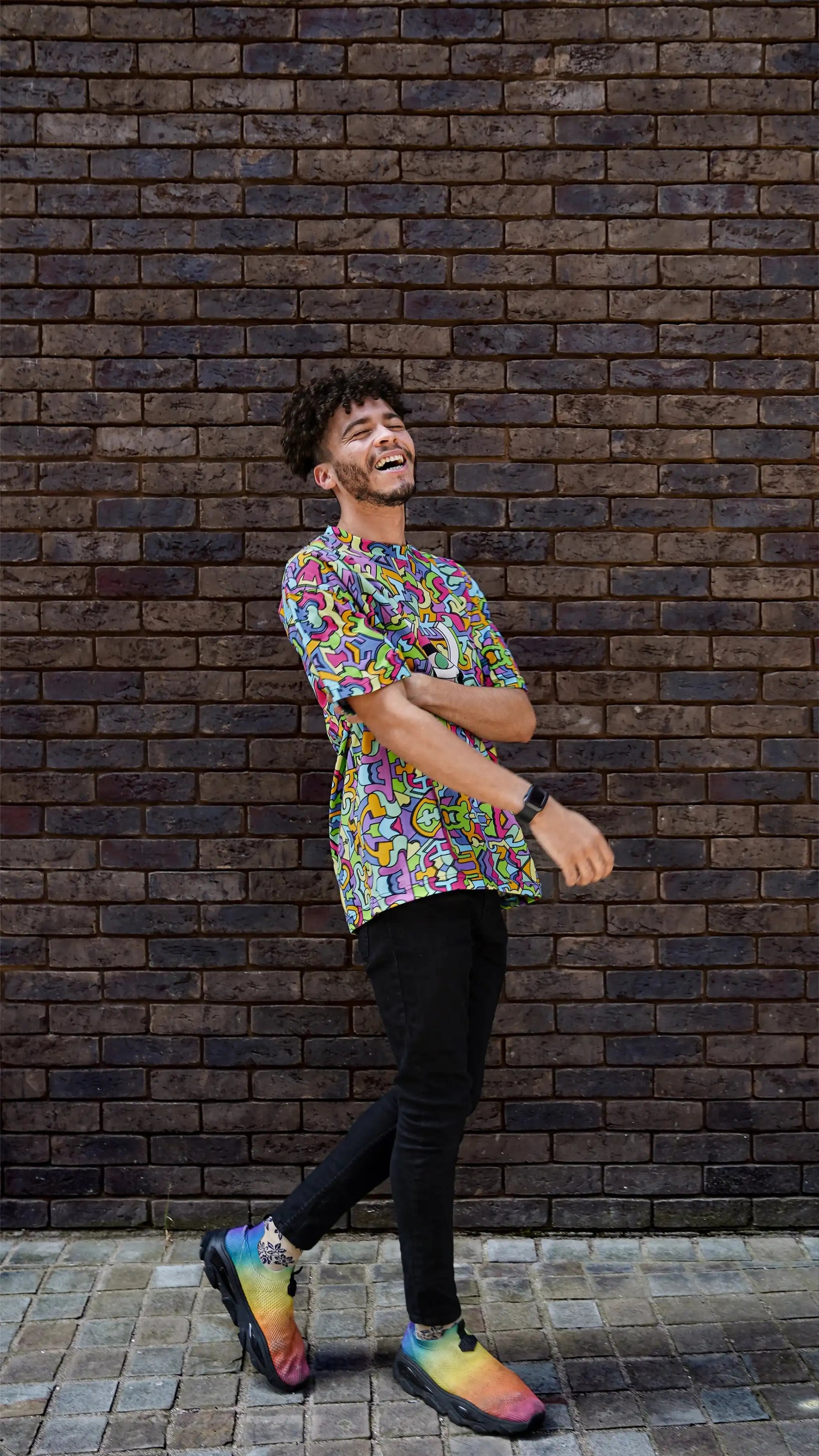 Model wearing Psychedelic Tee with colourful pattern.