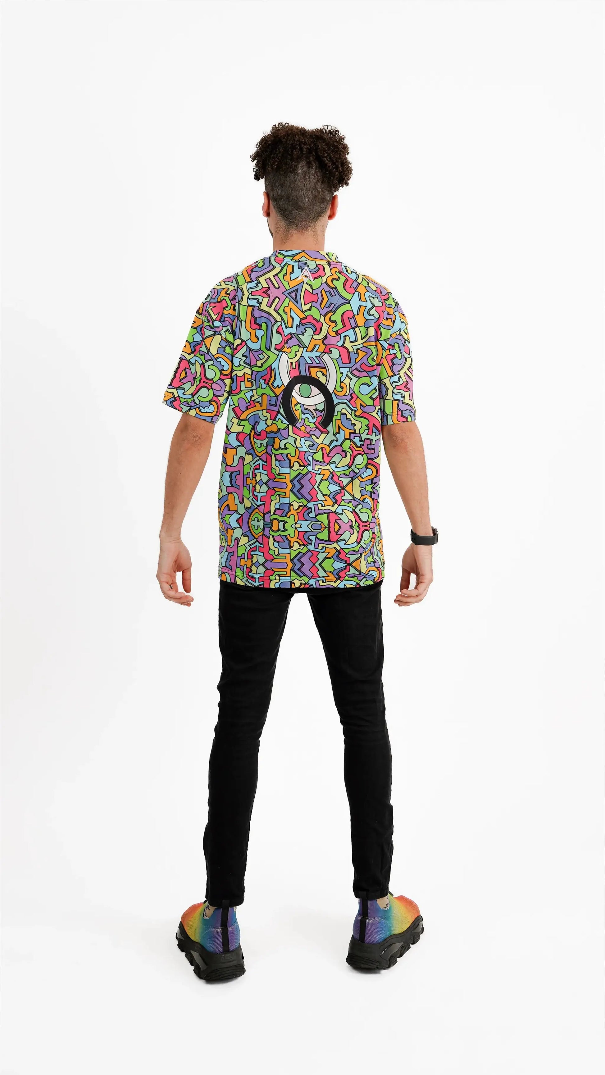 Model wearing Psychedelic Tee with colourful pattern.